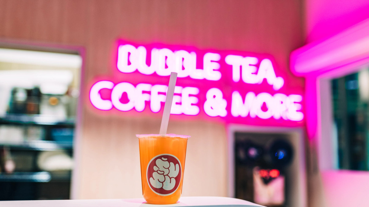 Bubble tea storefront with pink illuminated lettering